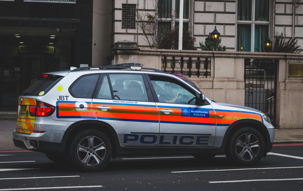 pexels photo 303313 303313 Police vehicle parked on an urban street outside a London building